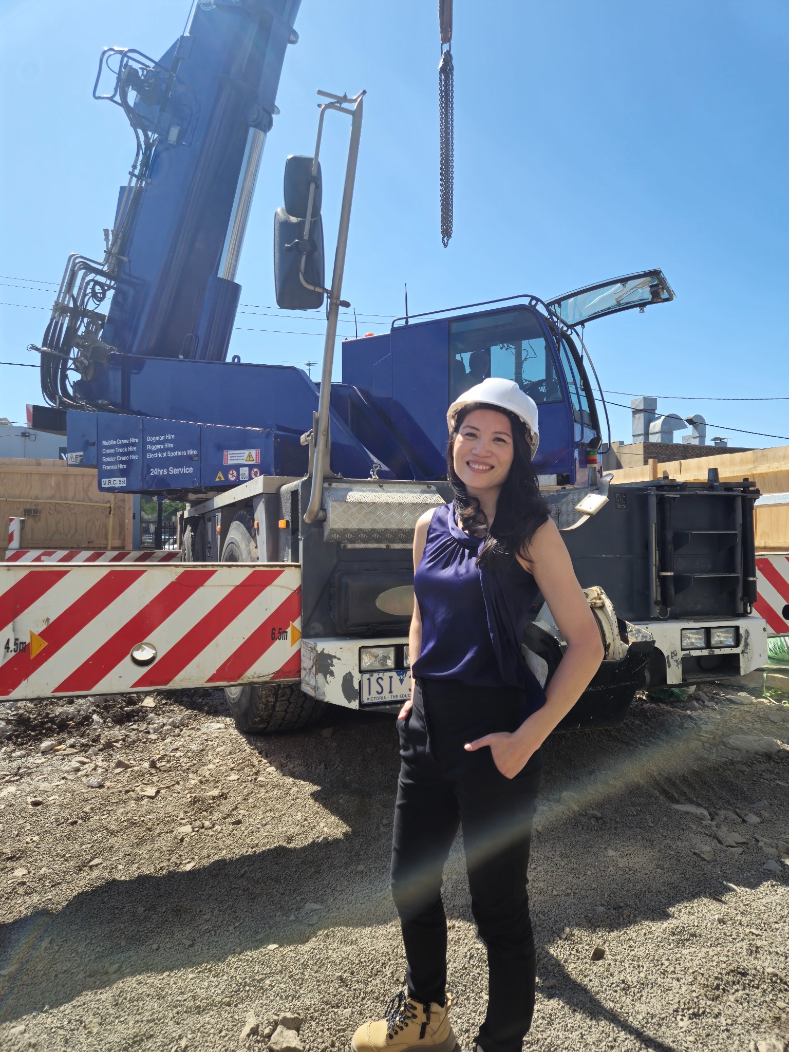 Ping at a construction site beside a crane